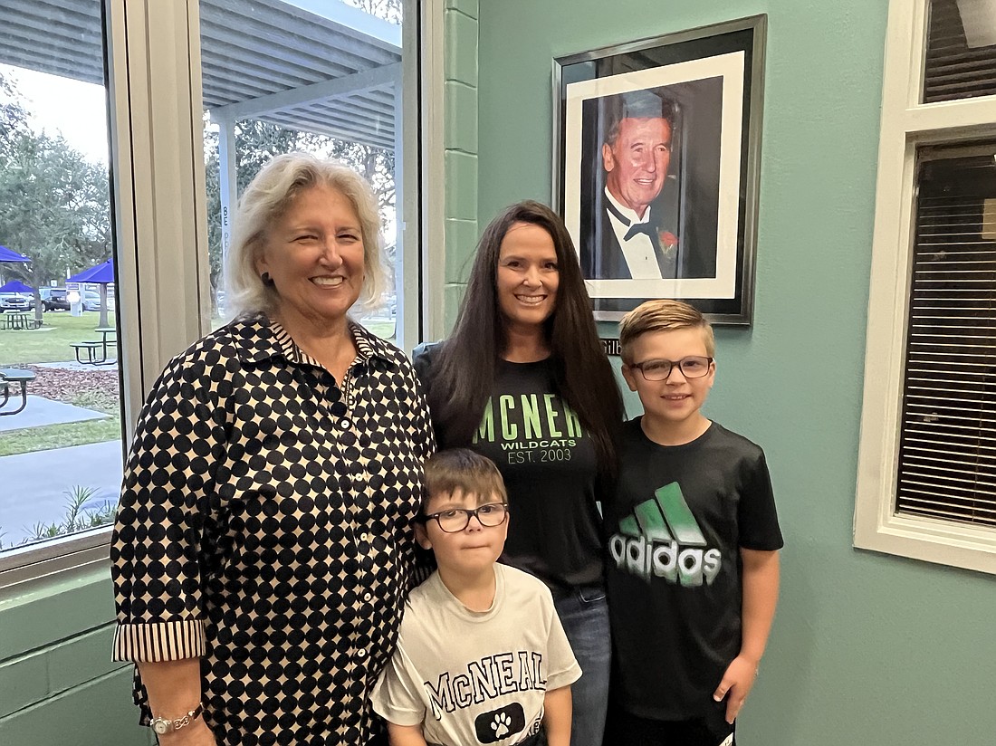 Ellenton's Barbara Bostrom, the niece of Gilbert McNeal, Lakewood Ranch's Jessica Chmielarski, the granddaughter of McNeal, and Dylan and Michael Chmielarski, the great-grandsons of McNeal, celebrate his legacy at Gilbert W. McNeal Elementary School's 20th anniversary.