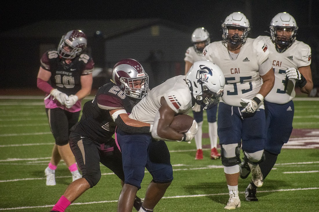 Rams junior James Griffitts (20) wraps up a CAI ballcarrier.