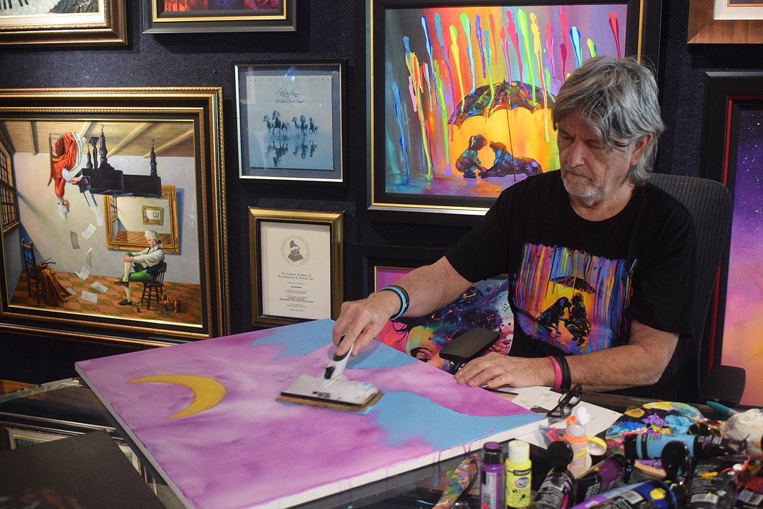 Jim Warren paints at his live art show at Wyland Galleries on Oct 14.