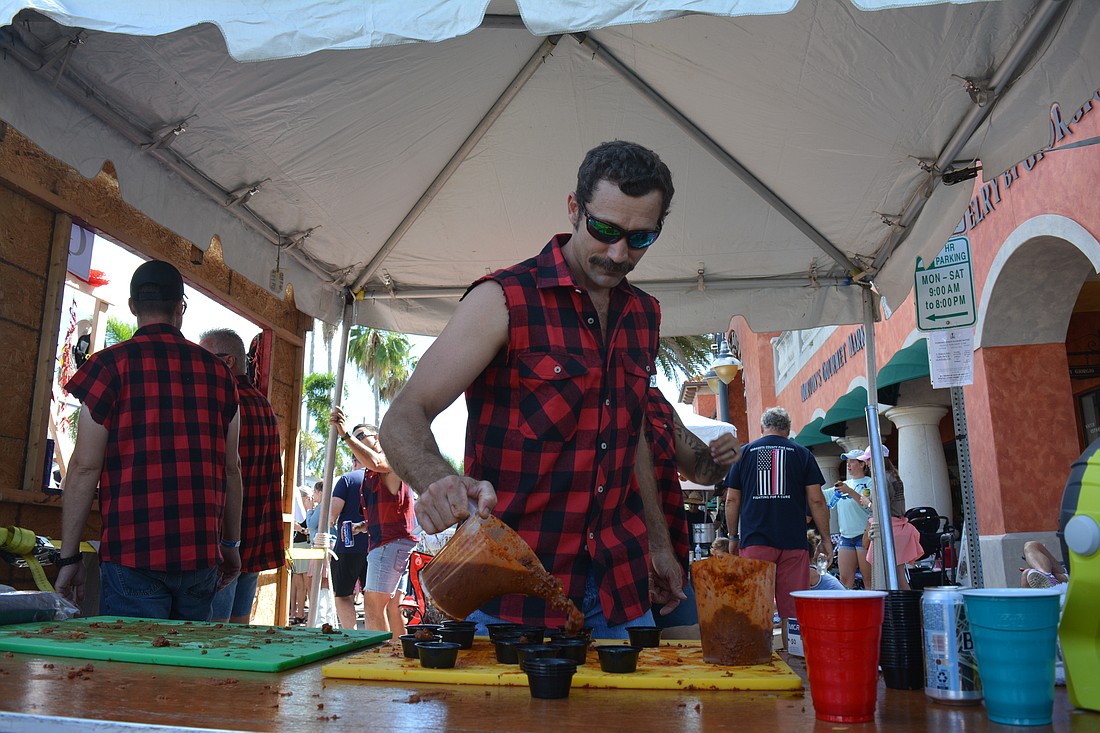 Blaze Belligan with Sarasota County Fire Station 11 prepped sample cups of their sweet chili.