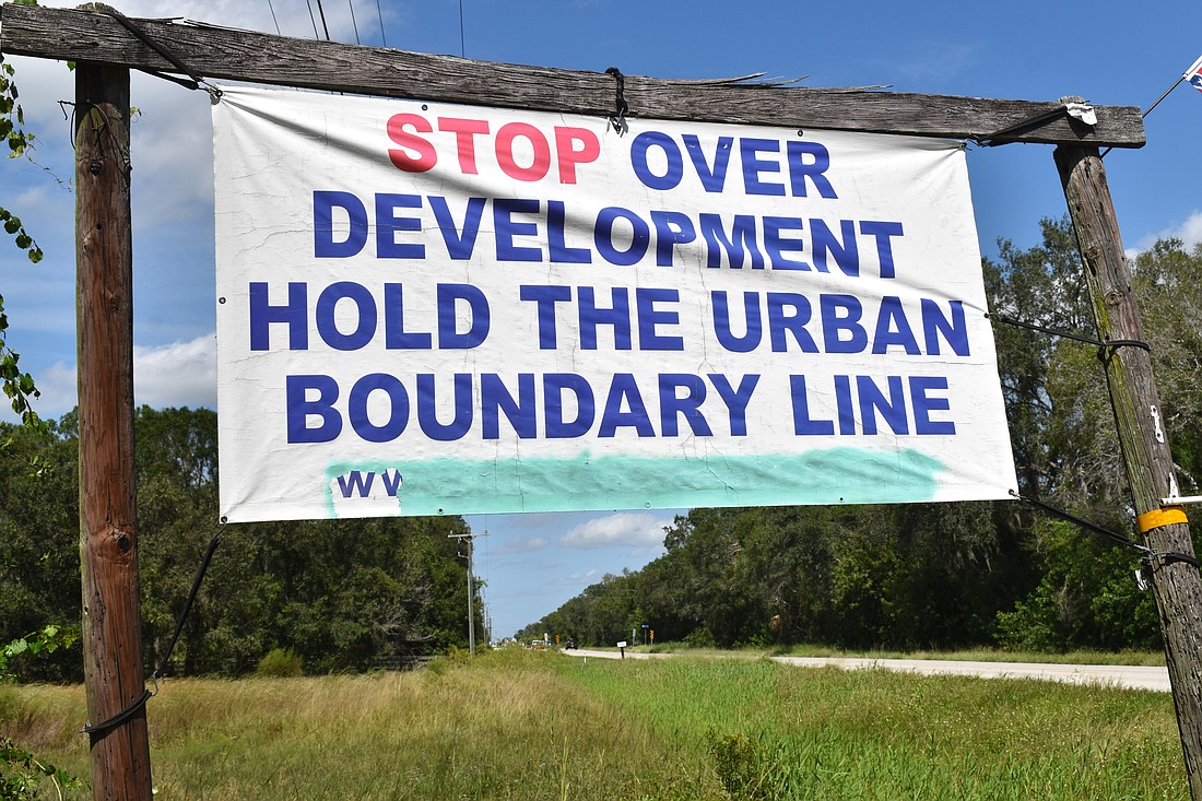 This sign hangs along County Road 675. Resident groups regularly ban together to attend commission meeting to prevent development east of the Future Development Area Boundary.