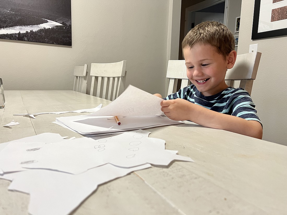 On Sunday, Luke was at the dining room table with white paper and scissors, as if his life depended on finishing this jagged ghost in the next five seconds. Photo by Brian McMillan