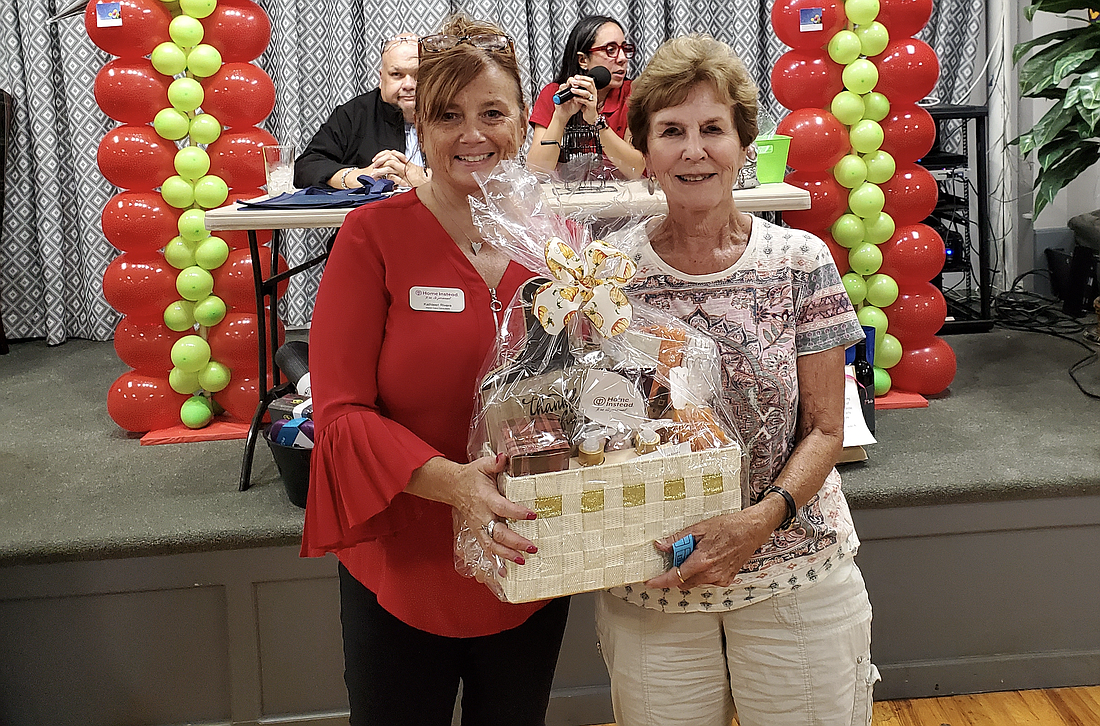 The Parkinson’s of Flagler Palm Coast Support Group raised $2,000 at its first fundraiser. Picture: volunteer Kathleen Rivera with a raffle winner. Photo courtesy of Parkinson’s of Flagler Palm Coast Support Group