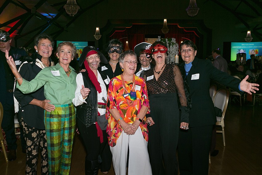 Partygoers dressed with the Masquerade Ball theme.
