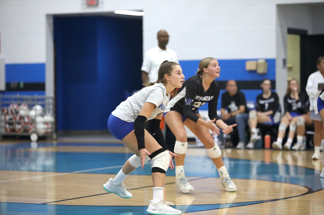 Matanzas libero Rylan Miller (left) gets ready to receive a serve in a game against Gainesville Buchholz on Oct. 16, 2023. File photo by Brent Woronoff