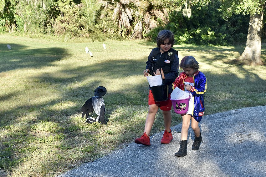 Luca Baldo, 8, and Della Baldo, 5, look over the candy they've found.