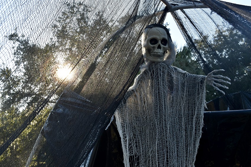 A skeleton hangs in an overhang along the bridge.