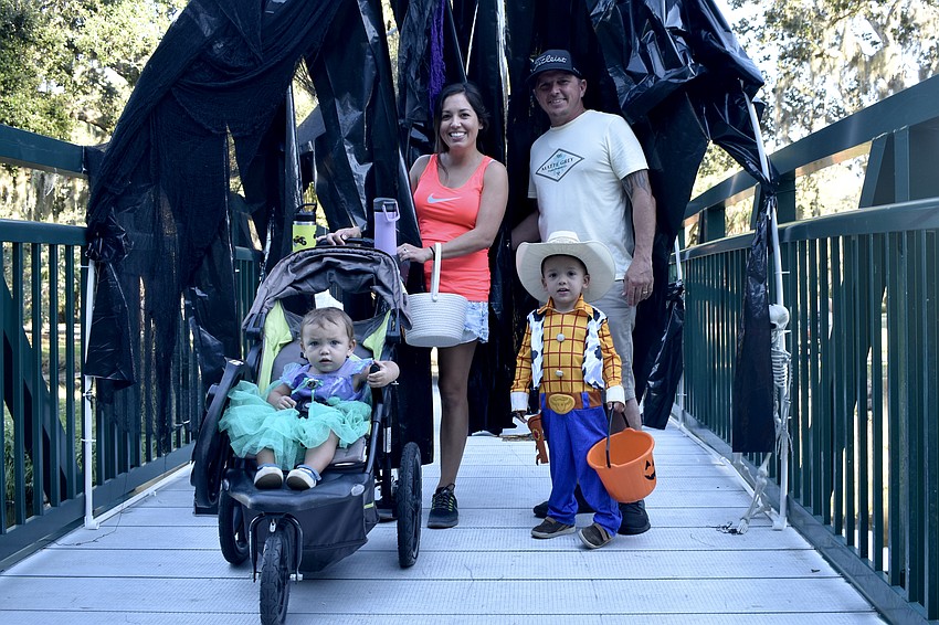 Camila Eskew, 1, Lauren and Colby Eskew, and Colby Eskew, Jr., 1, emerge from the tunnel atop the bridge.