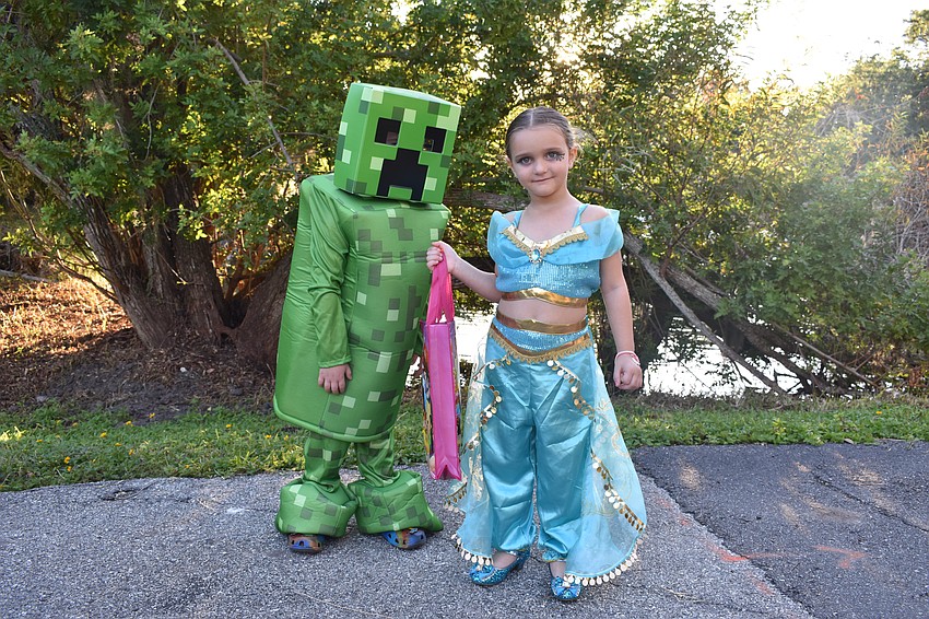 Junior Ortiz, 6, dressed as a creeper from Minecraft, while Ava Ortiz dressed as Jasmine.