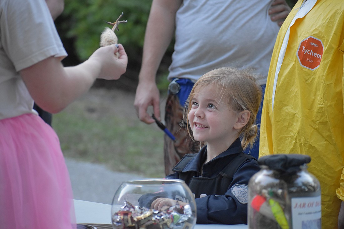 Sarah Rubin of Save Our Seabirds showcases a hawk foot to Finn Seth-Ward, 4.