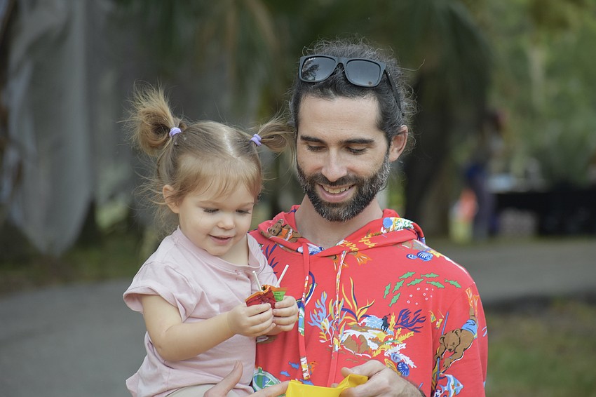 Margot Newman, 2, and her father Ben Newman look over some new Halloween candy.