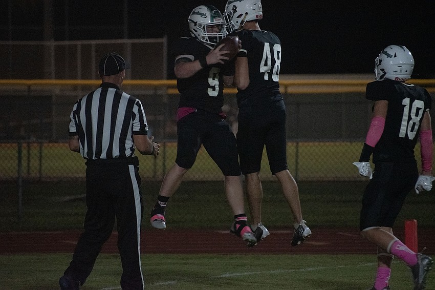 Lakewood Ranch senior running back Simon Freed (9) celebrates with Vincent Jovanovski (48) and Tyler McCoy (18) after a touchdown run.