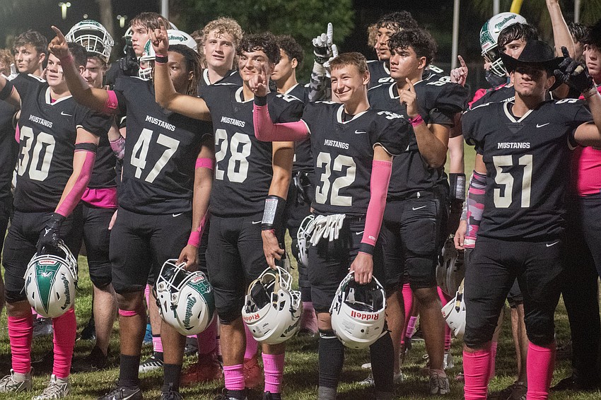 The Mustangs salute their student section following a 10-8 win over Gibbs High.