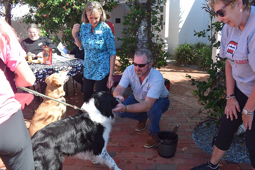 Reverend Brock Patterson blessing Mike and Lauren Ehlers's dog Maverick