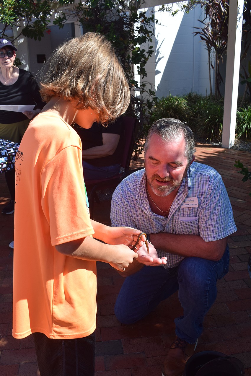 Reverend Brock Patterson blessing Aidan Dwyer's snake Marv