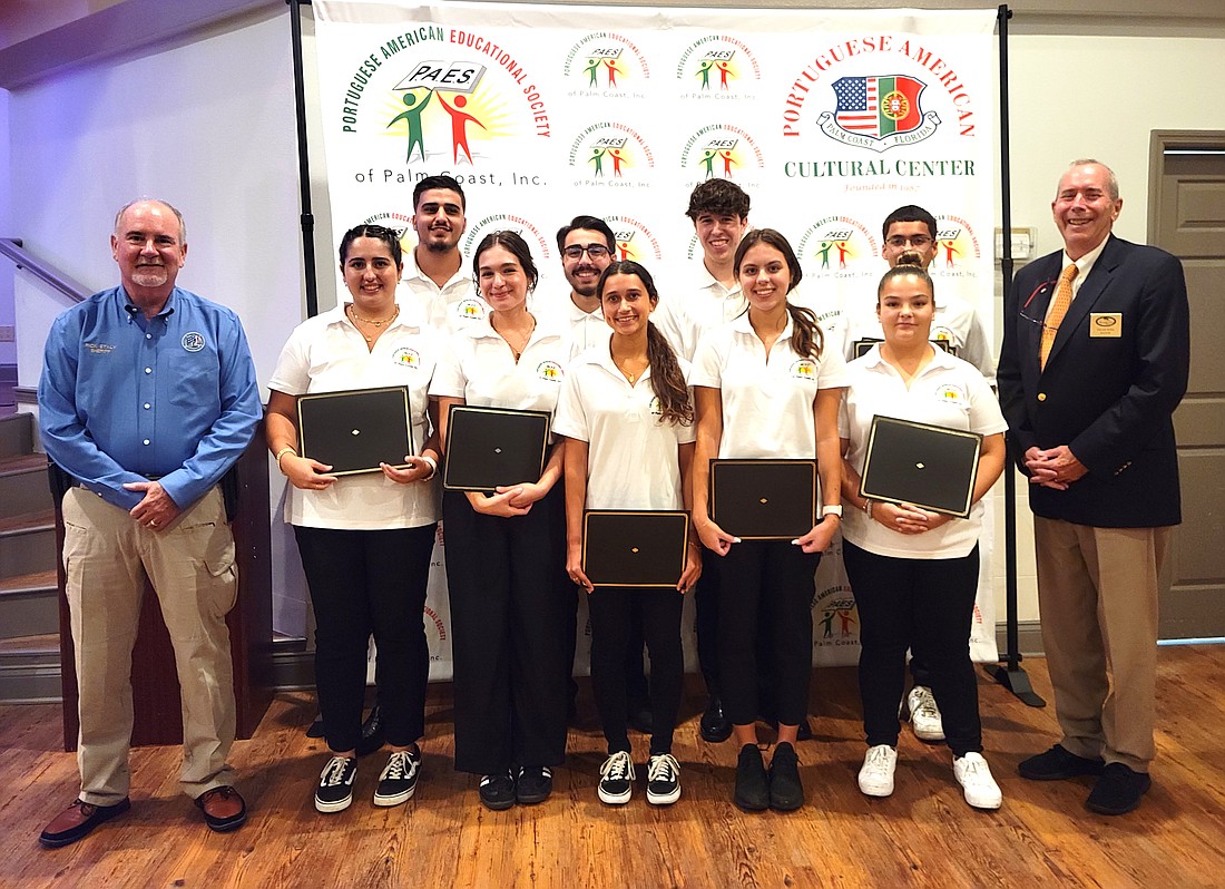 Flagler County Sheriff Rick Staly and Palm Coast Mayor David Alfin with the 10 PAES scholarship award recipients. Photo courtesy of the PAES