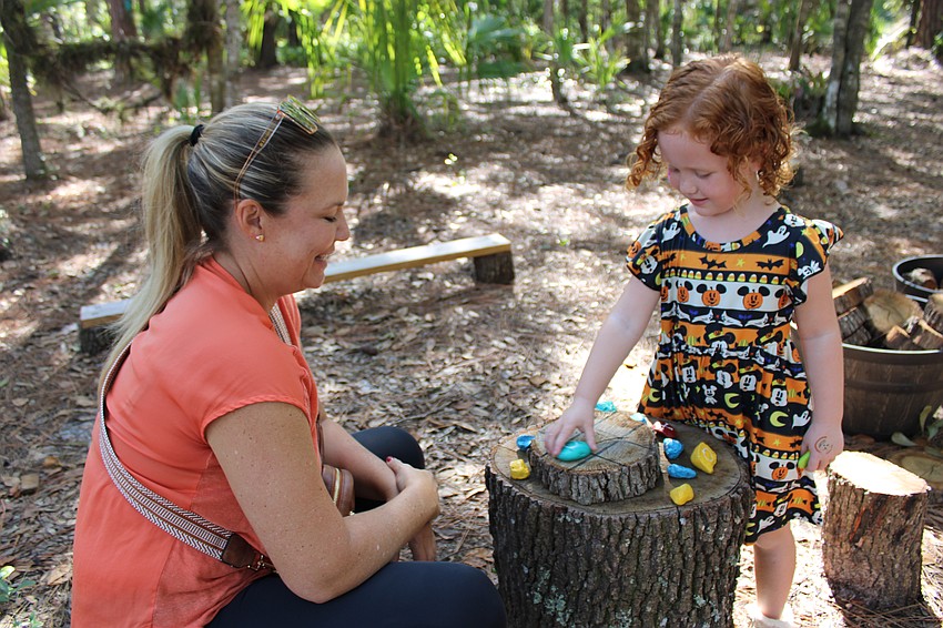 Amanda Hiney and her 5-year-old daughter Brynlee stopped along the path for a game of tic-tac-toe.