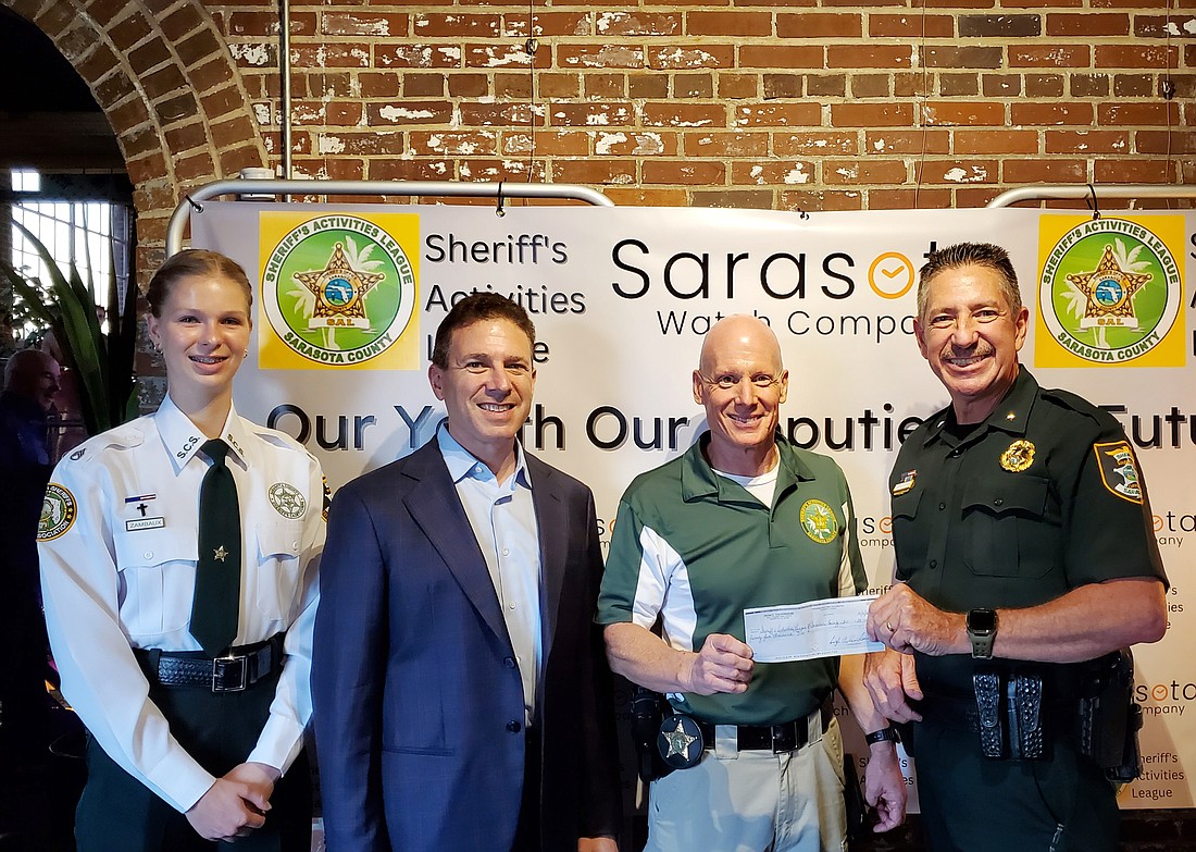 Anais Zambaux, Lance Karp, DeWayne Hill and Sheriff Kurt Hoffman. The SAL received a $25,000 donation from the Culverhouse family.