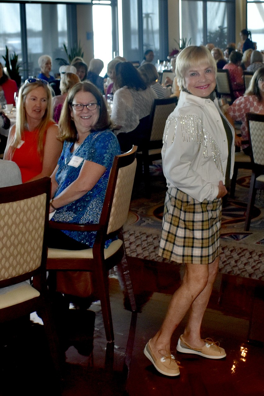 Caroline Resnick and Cathy Worster admire model Laura Dolard's outfit.