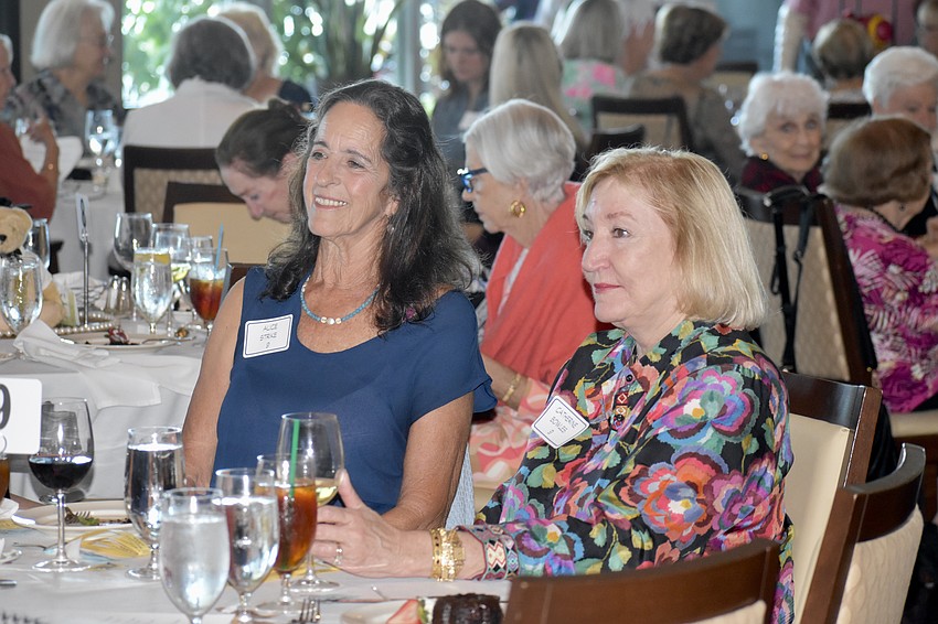 Alice Strike and Catherine Bowles watch the fashion show.