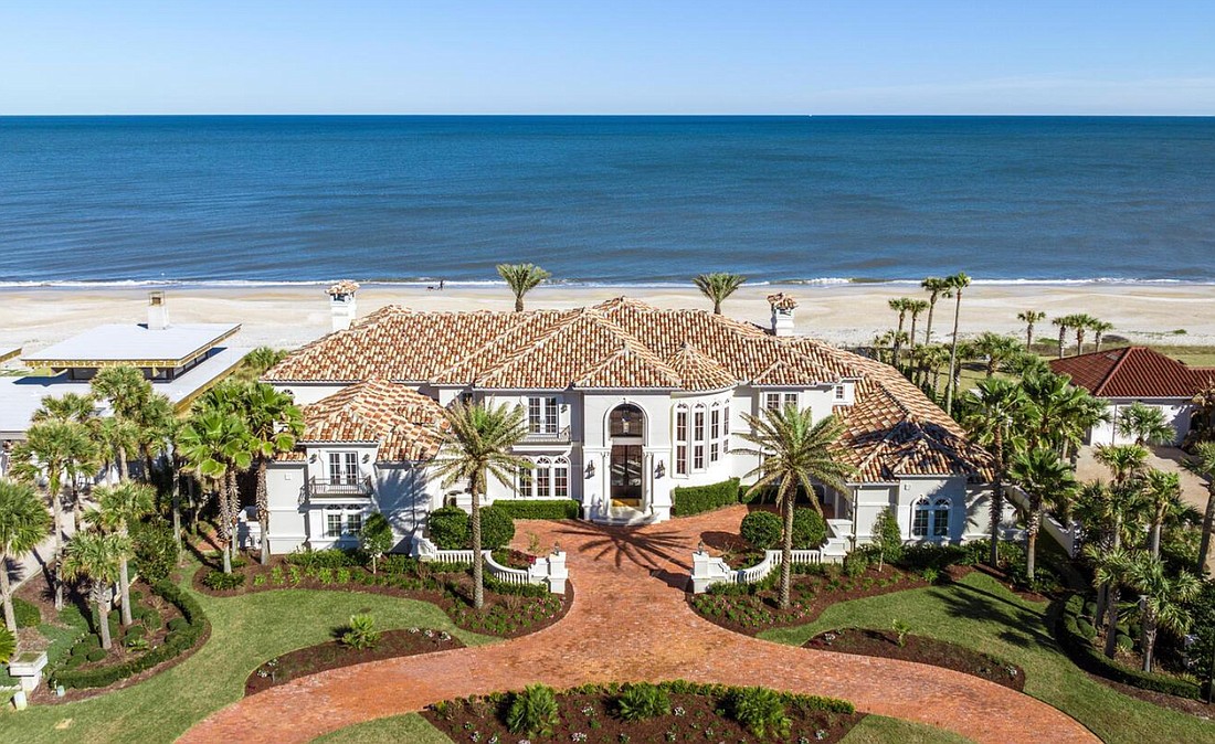 Oceanfront Mediterranean-style, two-story home features, six bedrooms, seven full and two half-bathrooms, office, game room, elevator, butler’s pantry, outdoor entertainment area, porches, balcony, summer kitchen, pool and dune walkover.