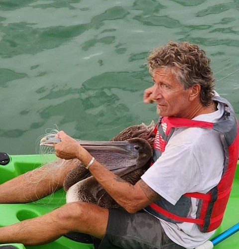 Leo Kissling with the rescued brown pelican.