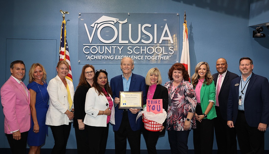 Lowell and Nancy Lohman (center) with Volusia County Schools staff and board members. Photo courtesy of Volusia County Schools