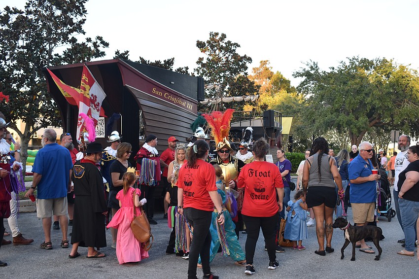 The Crewe of De Soto display their ship and hand out beads.