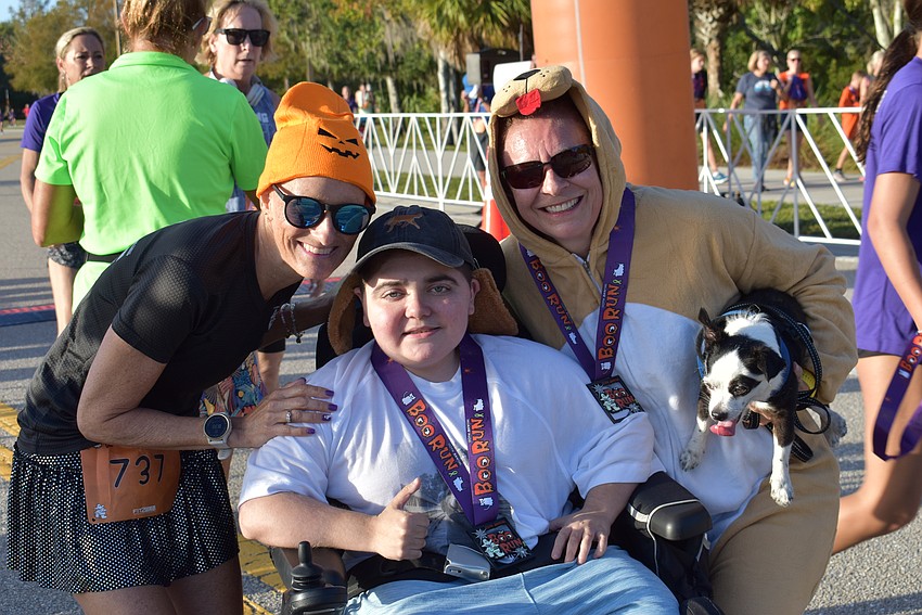 Jen Tullio, Grayson Tullio and Monika Oberer celebrate the finish of another successful Boo Run, which drew approximately 500 runners on Saturday to Lakewood Ranch.