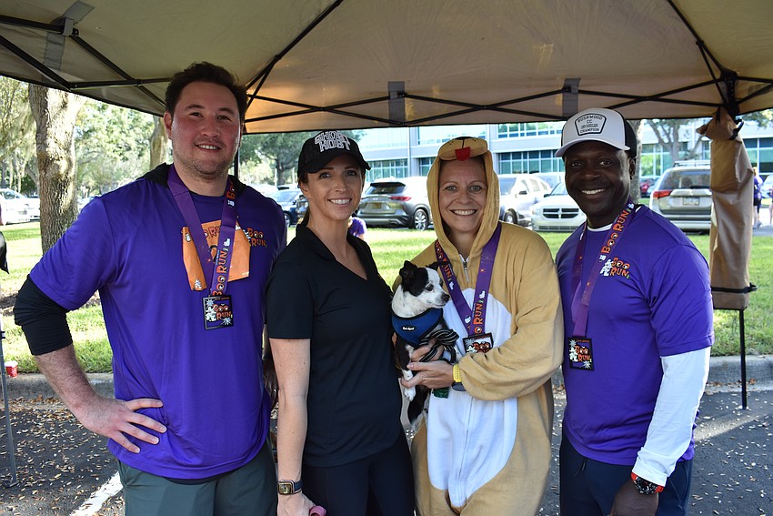 Matthew Sonneman, vice president of sales of Sonneman — A Way of Light, flew from New York City just to support the Boo Run charities. He is with Shawna Spaziani, Monika Oberer and Woodford Joseph.