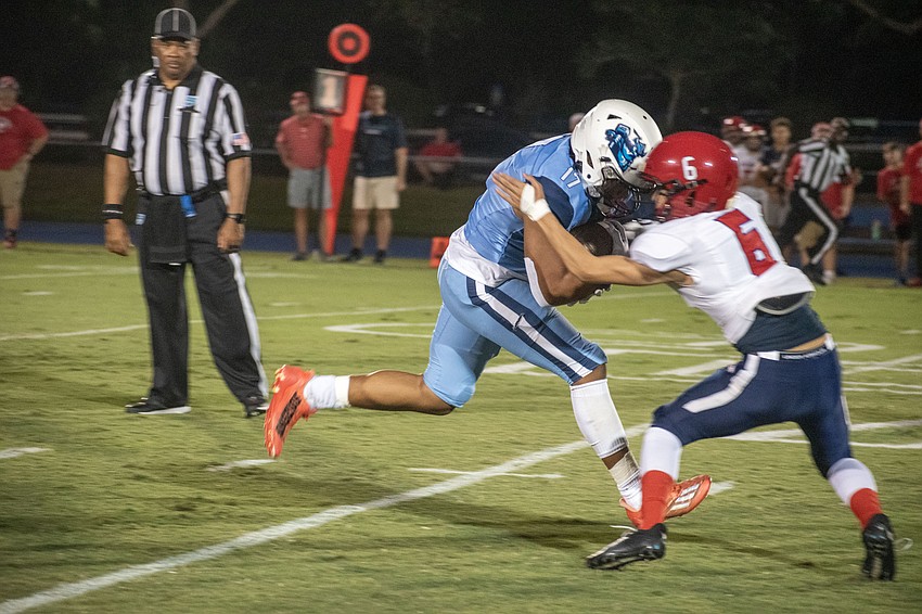ODA sophomore running back Allen Clark lowers his shoulder into All Saints' Academy sophomore Jaelen Randall (6).