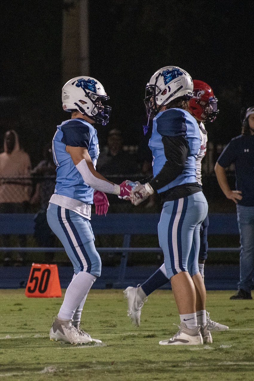 ODA senior Jack Taraska and senior Colin Mucha shake hands after a Taraska interception against All Saints' Academy.