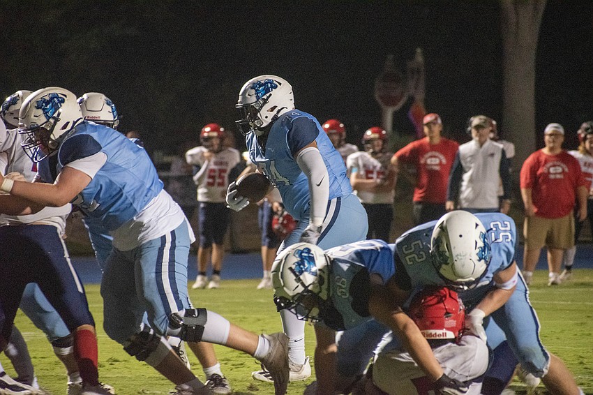 ODA junior guard Marvin Palominos rumbles with the football in a goal-line situation against All Saints' Academy.