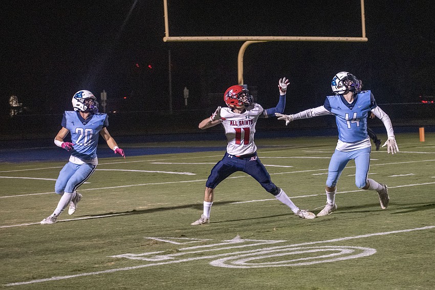 ODA senior Jack Taraska (20) and junior Tommy Orie (14) guard All Saints' Academy senior Andrew Foppe (11) on a deep pass. The pass would fall incomplete.
