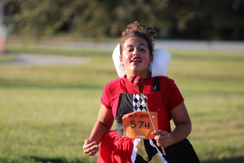Sarasota's Alice Nouri, 12, was a running ace even though she was dressed as the Queen of Hearts in the Boo Run.
