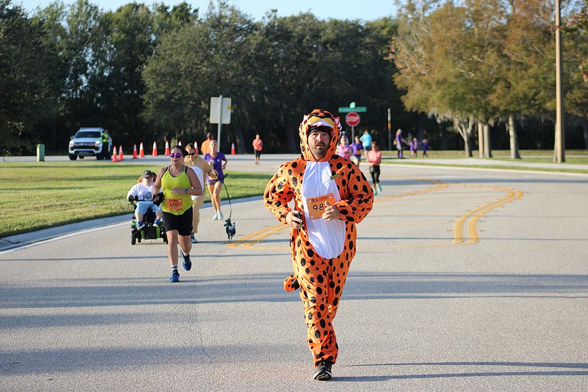 Bradenton's Jacob Woodard finishes the Boo Run in his Cheetos outfit. 