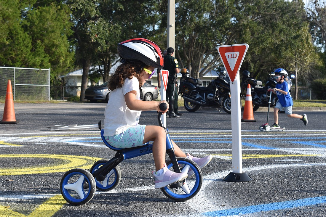 Angelina Van Slyck learns the rules of the road at McNeal Elementary School on Oct. 28 during Manatee County's Mobility Week.