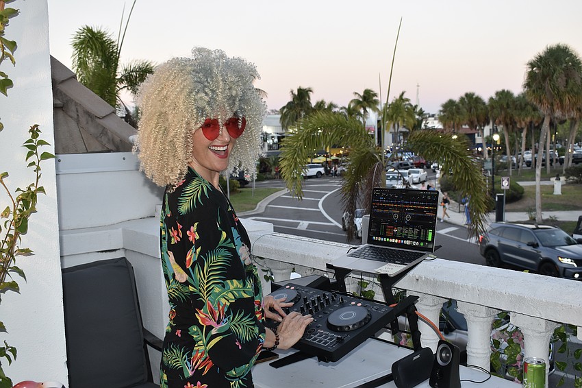 Layla Ellis (DJ Solove) plays music from the balcony of Gauthier Salon & Wellness Spa.