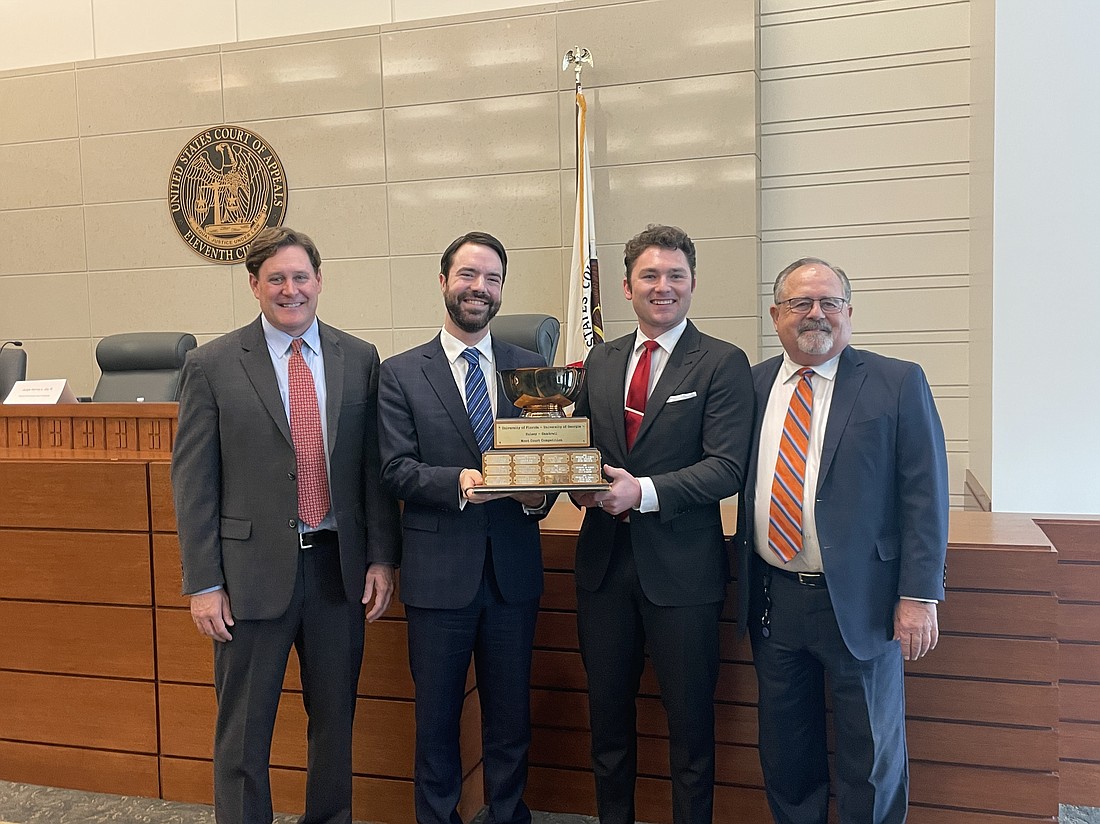 The team from the University of Florida won the 2023 Hulsey-Gambrell Florida-Georgia Moot Court Competition on Oct. 27. From left, attorney Scott Gallagher of Smith Gambrell Russell; University of Florida law students Samuel Budnyk and Logan Edwards and attorney Lanny Russell of Smith Hulsey Busey.