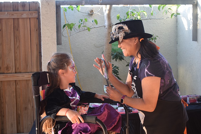 Wendy Chapus getting her face painted by Akiko Graphics
