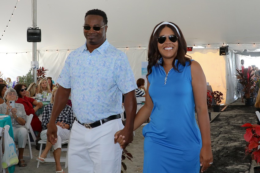 Odie Harris, former football starter for the Tampa Bay Bucs, 1988-1990, and his wife, Bianca, walk the runway.