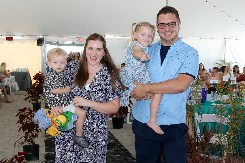 Two-year old William, Renee, Brianna, 3, and Ryan  Sensenbrenner walk the runway as a family.