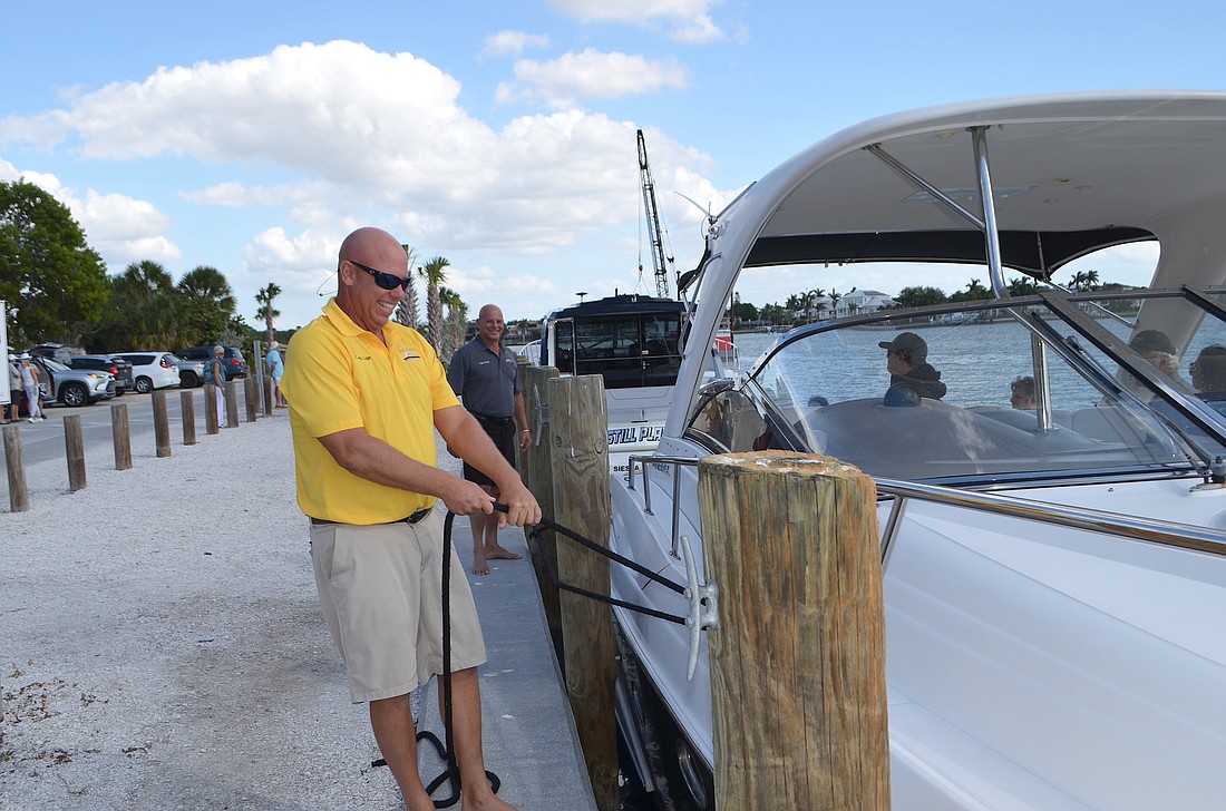Luke LaGorin (yellow shirt) and Frank Martinelli tie off one of two Private Custom Charters boats at Nora Patterson Island Park on Siesta Key.