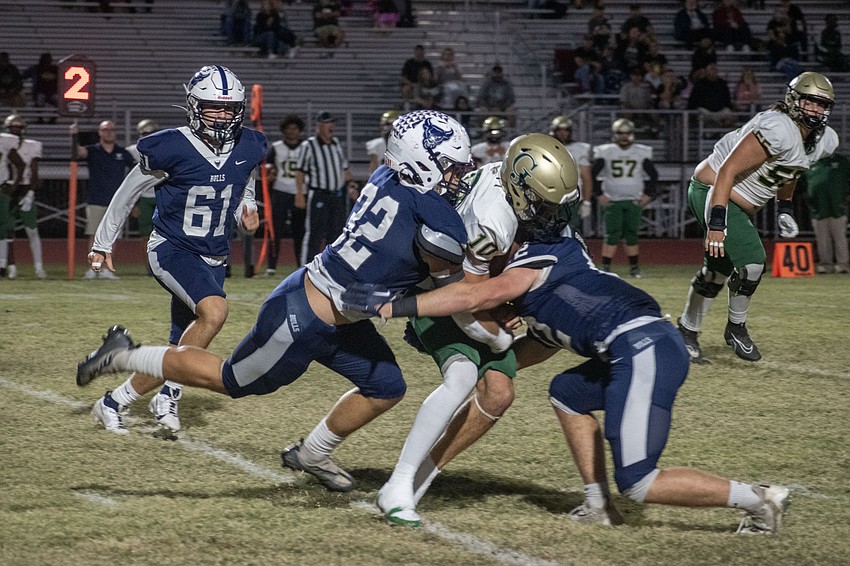 Bulls junior Ben Biasini (32) and junior Gage Cameron put a tandem tackle on George Jenkins quarterback Cameron Turner (10).