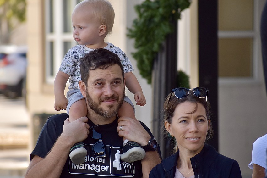 Jacob Kozlow, 1, and Adam and Rebecca Kozlow watch the competition.