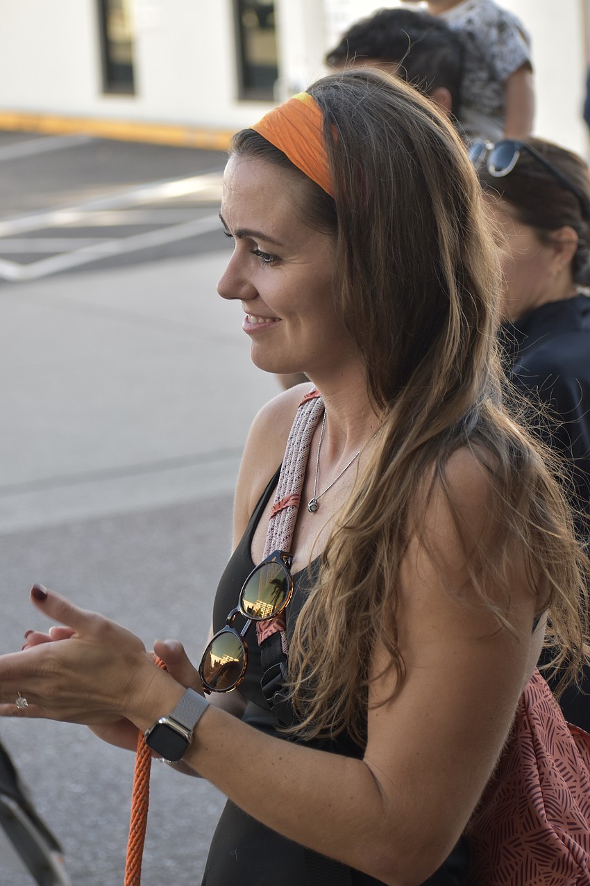 Nikki Day applauds the contestants.