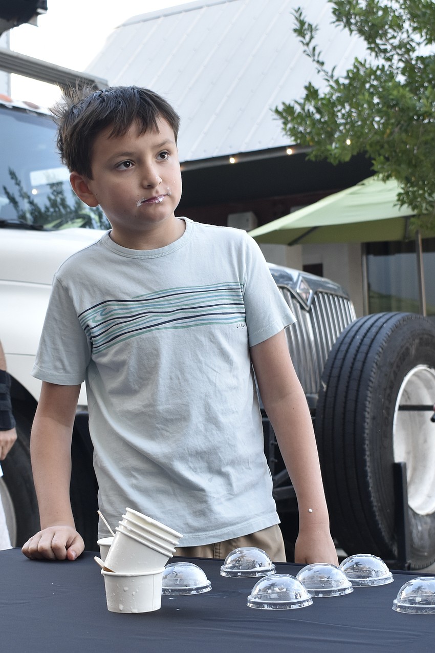 Ivan Gorodnitchev, 10, stands with his emptied containers after finishing the competition. Gorodnitchev described himself as 