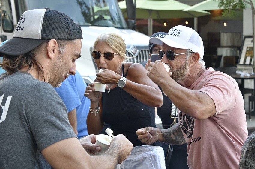 Ben Gallaher of Seaward CrossFit and Patti Lawson and Paul Leonard of PLT Nutrition gulp down the ice cream.