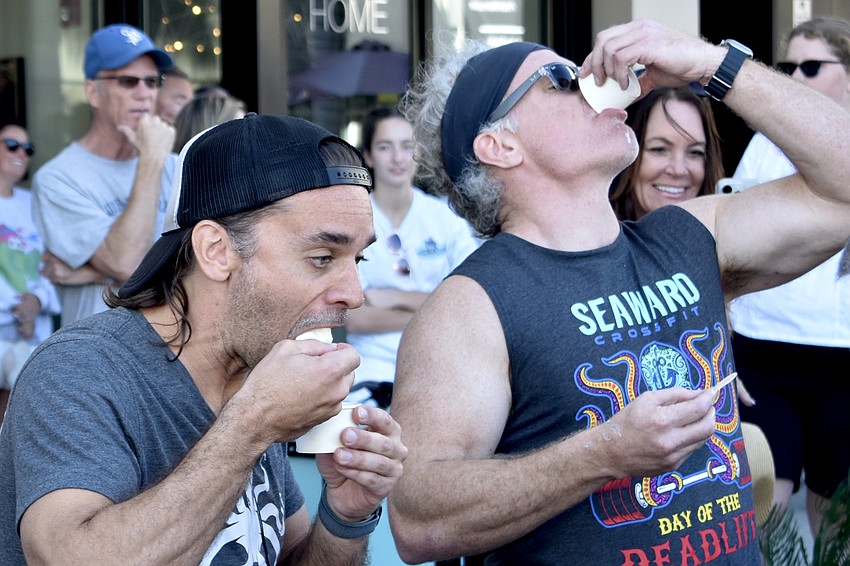 Ben Gallaher and Tim Riesen of Seaward CrossFit make their way through containers of ice cream.