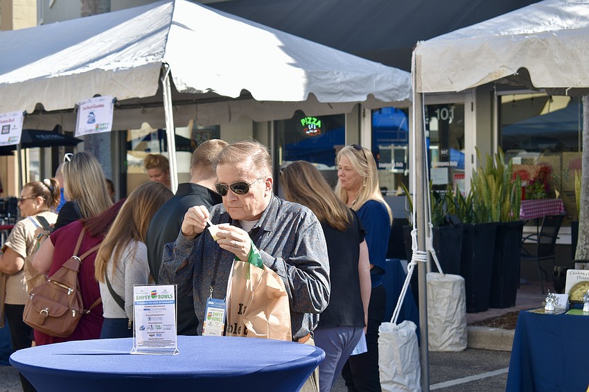 Neal Communities employee David Goben tries the chicken artichoke florentine soup from the Chicken Salad Chick.
